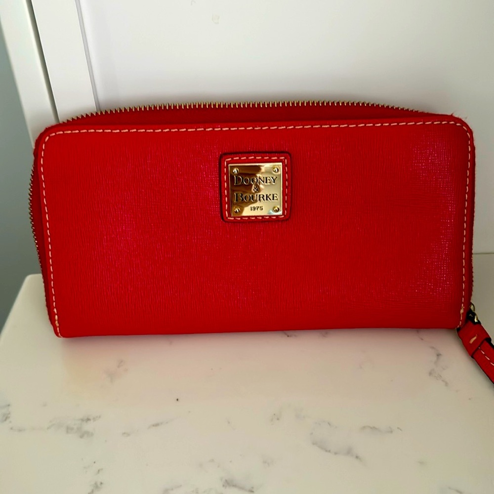 Dooney and Bourke up around wallet. Like new, no scratches or marks!